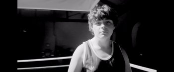 Movie still from “Flora and Son” (2023), directed by John Carney – A young man in a black and white photo; Close Up shot, High angle