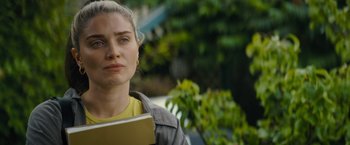 Movie still from “Flora and Son” (2023), directed by John Carney – A woman is holding a book in her hands; Close Up shot, Over the shoulder angle