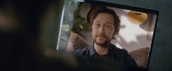 Movie still from “Flora and Son” (2023), directed by John Carney – A man's face in a mirror; Close Up shot, Over the shoulder angle