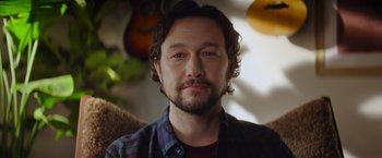 Movie still from “Flora and Son” (2023), directed by John Carney – A person wearing a plaid shirt; Close Up shot, Low angle