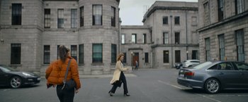 Movie still from “Flora and Son” (2023), directed by John Carney – A woman walking down the street in a city; Wide shot, Low angle