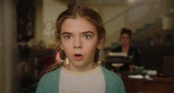 Movie still from “Flora & Ulysses” (2021), directed by Lena Khan – A young girl with a surprised look on her face; Close Up shot, Over the shoulder angle