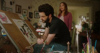 Movie still from “Flora & Ulysses” (2021), directed by Lena Khan – A man and a woman are painting a picture together; Medium shot, Over the shoulder angle