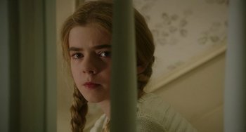 Movie still from “Flora & Ulysses” (2021), directed by Lena Khan – A young girl with long blonde hair looking at the camera; Close Up shot, High angle