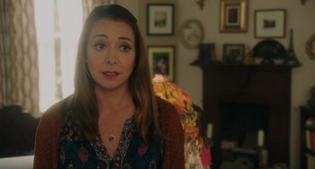 Movie still from “Flora & Ulysses” (2021), directed by Lena Khan – A person in a living room near a fire place; Close Up shot, Over the shoulder angle