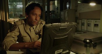 Movie still from “Flora & Ulysses” (2021), directed by Lena Khan – A police officer is looking at a computer screen; Close Up shot, Low angle