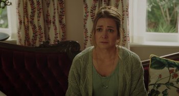 Movie still from “Flora & Ulysses” (2021), directed by Lena Khan – A woman sitting on a couch looking sad; Close Up shot, Over the shoulder angle