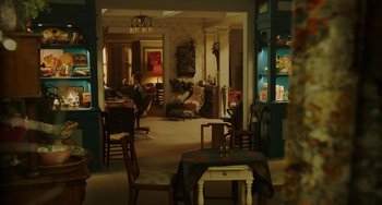 Movie still from “Flora & Ulysses” (2021), directed by Lena Khan – A living room filled with lots of furniture; Wide shot, High angle