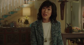 Movie still from “Flora & Ulysses” (2021), directed by Lena Khan – A woman wearing a blue jacket and a white shirt; Medium shot, Over the shoulder angle