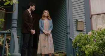 Movie still from “Flora & Ulysses” (2021), directed by Lena Khan – A man and a woman standing on the steps of a house; Wide shot, Low angle