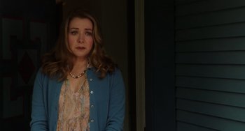 Movie still from “Flora & Ulysses” (2021), directed by Lena Khan – A woman in a blue jacket standing next to a door; Medium shot, Over the shoulder angle