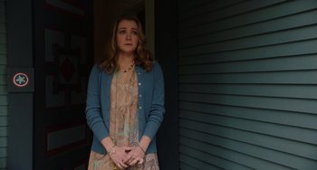 Movie still from “Flora & Ulysses” (2021), directed by Lena Khan – A woman standing in front of a building with her hands crossed; Medium shot, Over the shoulder angle