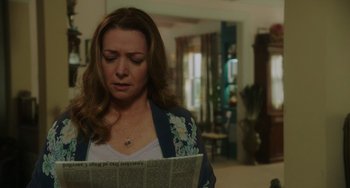 Movie still from “Flora & Ulysses” (2021), directed by Lena Khan – A woman reading a newspaper in a living room; Close Up shot, Over the shoulder angle