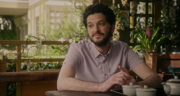 Movie still from “Flora & Ulysses” (2021), directed by Lena Khan – A man sitting at a table with a cup of coffee; Close Up shot, Over the shoulder angle