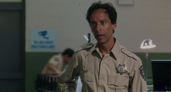 Movie still from “Flora & Ulysses” (2021), directed by Lena Khan – A man in a uniform is standing in front of a wall; Close Up shot, Over the shoulder angle