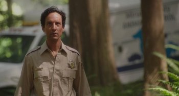 Movie still from “Flora & Ulysses” (2021), directed by Lena Khan – A man in a uniform standing in front of a tree; Close Up shot, Low angle