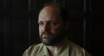 Movie still from “Flux Gourmet” (2022), directed by Peter Strickland – A person with a beard; Close Up shot, Low angle