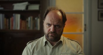 Movie still from “Flux Gourmet” (2022), directed by Peter Strickland – A person wearing a shirt; Close Up shot, Low angle