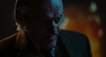 Movie still from “Flux Gourmet” (2022), directed by Peter Strickland – An old man with a beard is looking at the camera; Extreme Close Up shot, Over the shoulder angle