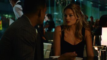 Movie still from “Focus” (2015), directed by John Requa – A man and a woman sitting at a dinner table; Close Up shot, Over the shoulder angle