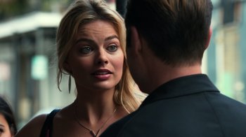 Movie still from “Focus” (2015), directed by John Requa – A man and a woman looking at one another; Close Up shot, Over the shoulder angle