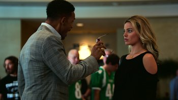 Movie still from “Focus” (2015), directed by John Requa – A man and a woman are talking to each other; Medium shot, Over the shoulder angle