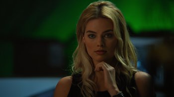 Movie still from “Focus” (2015), directed by John Requa – A beautiful blonde woman with long blonde hair; Close Up shot, Over the shoulder angle