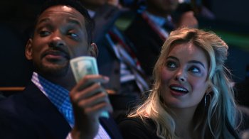 Movie still from “Focus” (2015), directed by John Requa – A man and a woman looking at a cell phone; Close Up shot, Over the shoulder angle