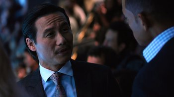 Movie still from “Focus” (2015), directed by John Requa – A person wearing a suit and a tie; Close Up shot, Over the shoulder angle