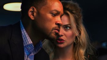 Movie still from “Focus” (2015), directed by John Requa – A man and a woman kissing in front of each other; Close Up shot, Low angle