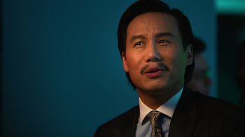 Movie still from “Focus” (2015), directed by John Requa – A person wearing a suit and tie; Close Up shot, Low angle