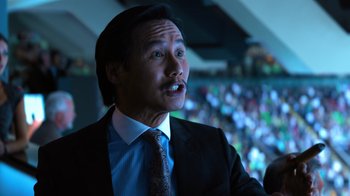 Movie still from “Focus” (2015), directed by John Requa – A person wearing a suit and tie; Close Up shot, Low angle