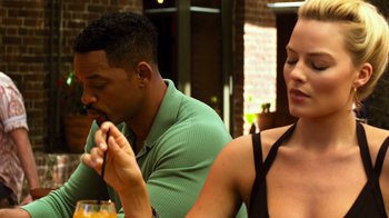 Movie still from “Focus” (2015), directed by John Requa – A man and a woman sitting at a table; Close Up shot, Over the shoulder angle