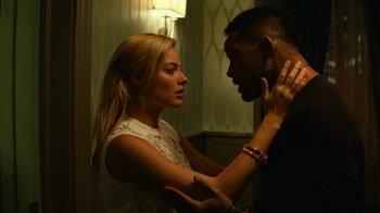 Movie still from “Focus” (2015), directed by John Requa – A man and a woman touching each other's neck; Close Up shot, Low angle