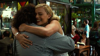 Movie still from “Focus” (2015), directed by John Requa – A woman hugging another woman in a checkered shirt; Close Up shot, Over the shoulder angle