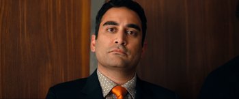 Movie still from “Fool's Paradise” (2023), directed by Charlie Day – A person wearing a suit and tie; Close Up shot, Low angle