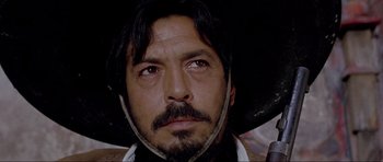 Movie still from “For a Few Dollars More” (1965), directed by Sergio Leone – A person wearing a hat; Close Up shot, Low angle