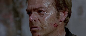 Movie still from “For a Few Dollars More” (1965), directed by Sergio Leone – A man's face covered in water; Close Up shot, Low angle