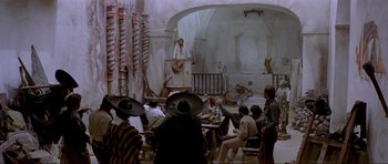Movie still from “For a Few Dollars More” (1965), directed by Sergio Leone – A group of people sitting around a table; Wide shot, Low angle