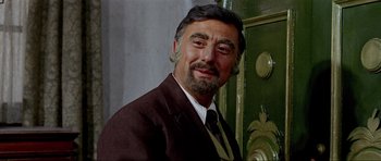 Movie still from “For a Few Dollars More” (1965), directed by Sergio Leone – A person wearing a suit and tie; Close Up shot, Low angle