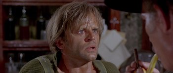 Movie still from “For a Few Dollars More” (1965), directed by Sergio Leone – A person with long blonde hair; Close Up shot, Low angle