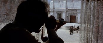 Movie still from “For a Few Dollars More” (1965), directed by Sergio Leone – A man is drinking from a wine bottle; Wide shot, Over the shoulder angle
