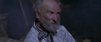 Movie still from “For a Few Dollars More” (1965), directed by Sergio Leone – An old man with a beard wearing a neck tie; Close Up shot, Low angle