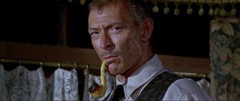 Movie still from “For a Few Dollars More” (1965), directed by Sergio Leone – A person with a pipe in his mouth; Close Up shot, Low angle