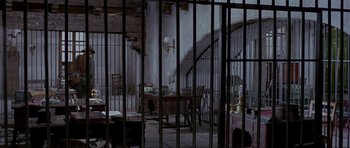 Movie still from “For a Few Dollars More” (1965), directed by Sergio Leone – A room filled with furniture and a table in the middle of the room; Wide shot, High angle