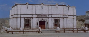 Movie still from “For a Few Dollars More” (1965), directed by Sergio Leone – A white building with a fire hydrant in front of it; Extreme Wide shot, Low angle