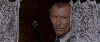 Movie still from “For a Few Dollars More” (1965), directed by Sergio Leone – A person holding a gun; Close Up shot, Low angle