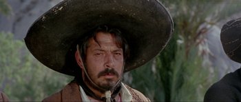Movie still from “For a Few Dollars More” (1965), directed by Sergio Leone – A man wearing a large hat and a beard; Close Up shot, Low angle