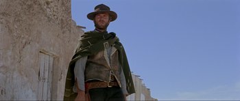Movie still from “For a Few Dollars More” (1965), directed by Sergio Leone – A man wearing a hat and a blanket; Medium shot, Low angle