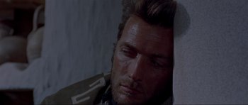 Movie still from “For a Few Dollars More” (1965), directed by Sergio Leone – A person with his head on a wall; Close Up shot, Low angle